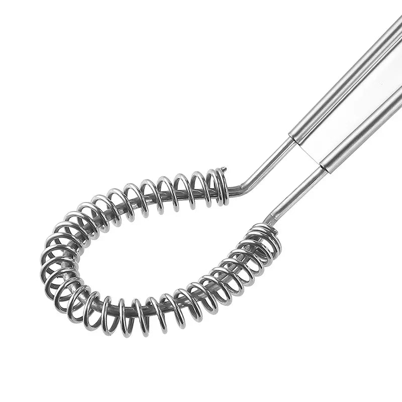 Metallic whisk with coiled beater on a white background
