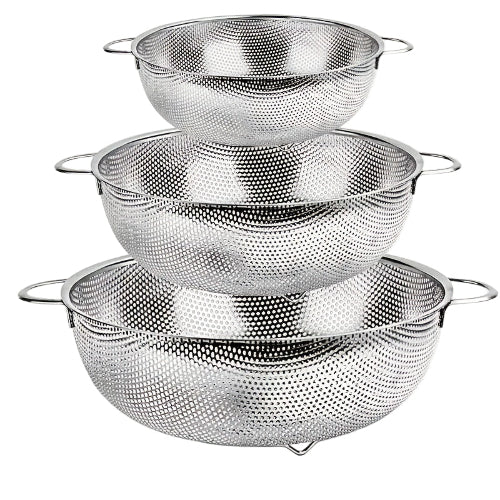 Set of three metal mesh colanders stacked on a white background