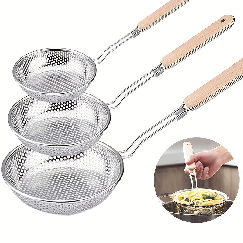 Set of three metal pasta sieves with wooden handles on a white background