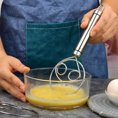 person whisking eggs with a steel danish batter whisk