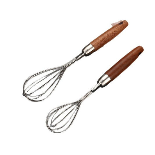 Two whisks with wooden handles on a white background