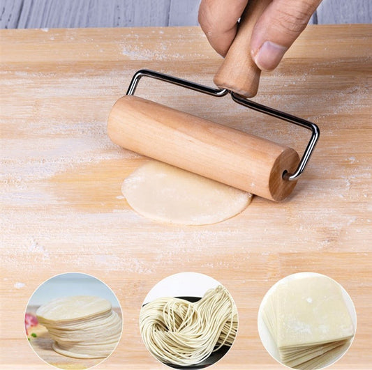person rolling dough on a wooden board with a mini wooden rolling pin