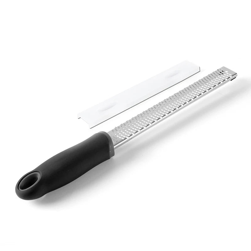 Metal grater with black handle on a white background